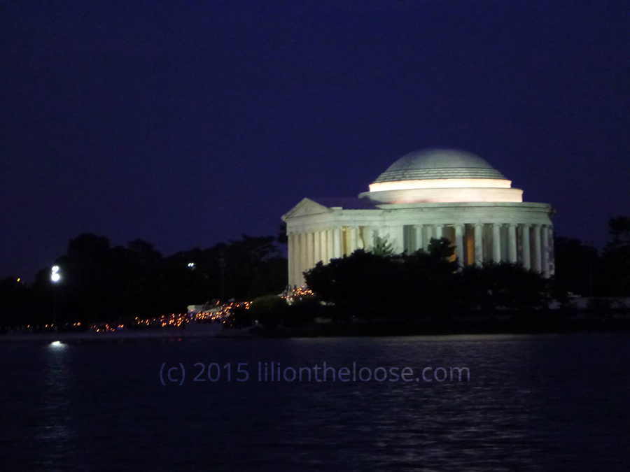Protesters in front of the Jefferson Memorial at night.