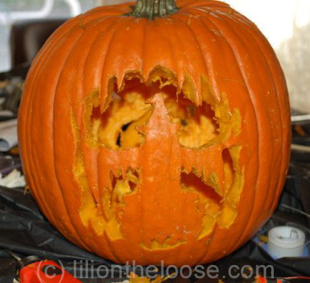 This is the front of a pumpkin, showing a witch in front of her cauldron!